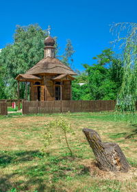 View of temple on field against building