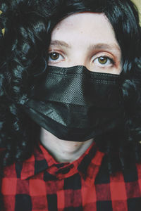 Close-up portrait of woman wearing protective face mask