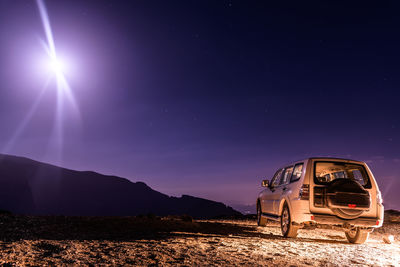 Abandoned car against sky at night