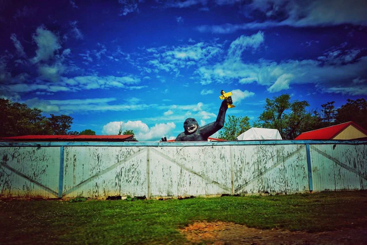 sky, lifestyles, full length, leisure activity, men, cloud - sky, built structure, architecture, building exterior, low angle view, cloud, side view, childhood, boys, outdoors, human representation, jumping