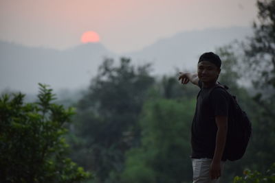 Man standing on mountain against sky