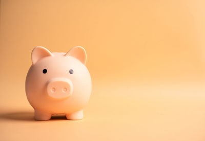 Close-up of a candle over pink background