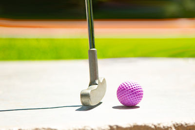 Close-up of golf club and ball