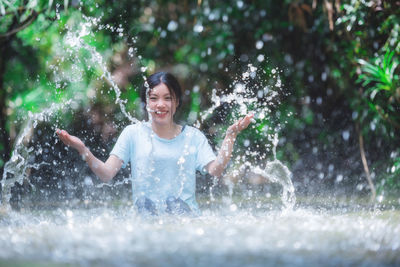 Young man splashing water