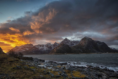 Scenic view of snowcapped mountains against sky during sunset