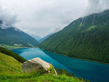 Scenic view of lake and mountains seen from cliff at alto adige