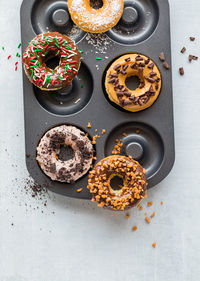 Top down view of a pan of delicious homemade donuts with copy space below.