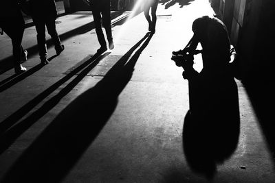 Conceptual silhouette of person begging on street