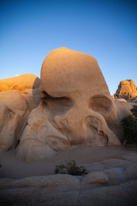 View of rock formations in desert against clear sky