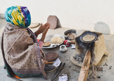 High angle view of woman preparing food on table