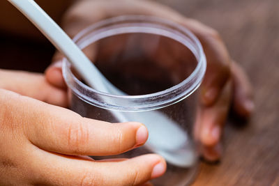 Close-up of person holding hands on table