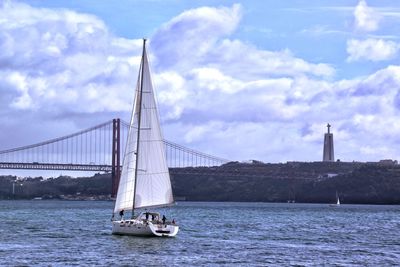 Sailboat sailing on sea against sky