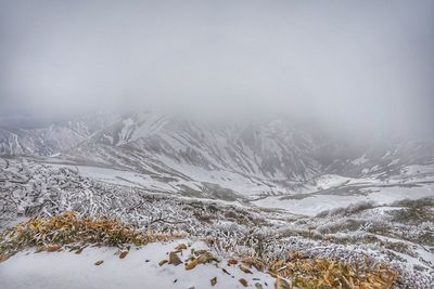 Scenic view of mountains against sky during winter