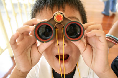 Close-up portrait of man holding sunglasses