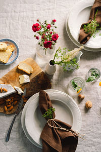 Vintage table setting with linen napkins and floral decorations. close up.