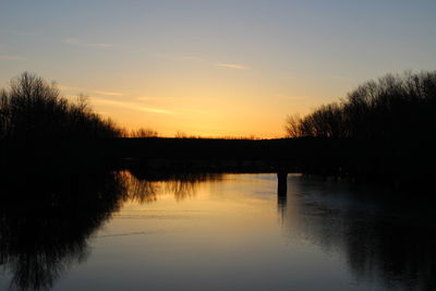 Scenic view of river at sunset