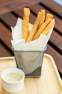 Close-up of bread and fries in plate on table