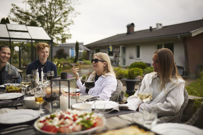 Friends having meal in garden