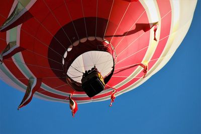 Low angle view of hot air balloon against clear blue sky