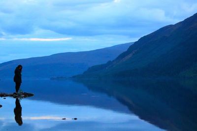 Scenic view of lake and mountains against sky