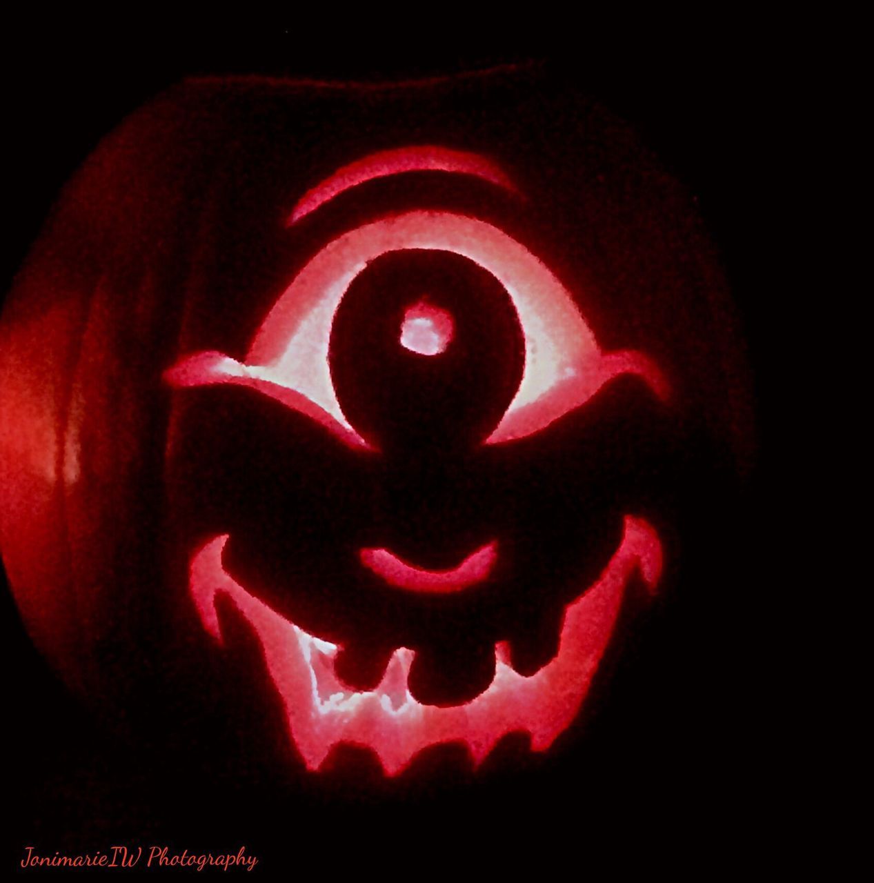 CLOSE-UP OF RED LIGHT OVER BLACK BACKGROUND