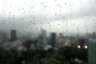 Full frame shot of wet glass window during rainy season