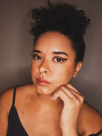Close-up portrait of woman against wall