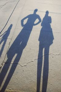 Shadow of people on sunny day