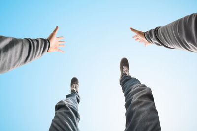 Low angle view of people against sky