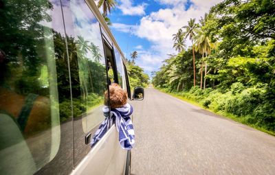 Rear view of boy in bus