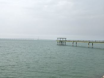 Pier over sea against sky