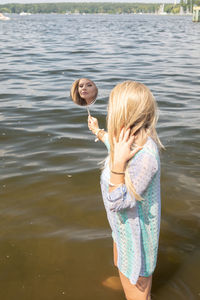 Siblings standing in lake