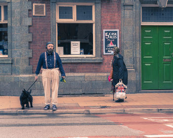 Man with dog on street in city