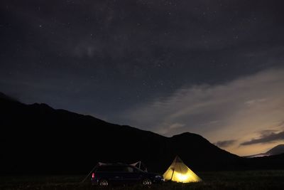 Scenic view of mountains against sky at night