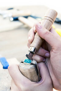 Cropped hands of woman working with tools at workshop