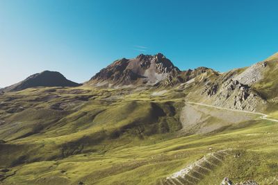 Scenic view of mountains against clear blue sky