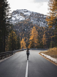 Woman walking on road during autumn