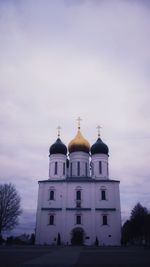 Low angle view of church against cloudy sky