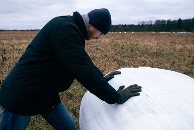 Side view of man standing on field