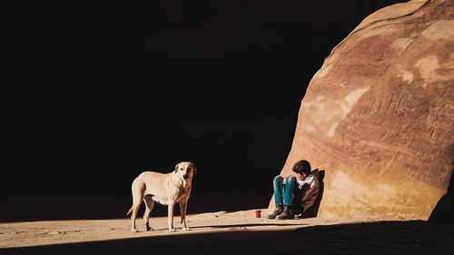 Men standing on rock formation against sky