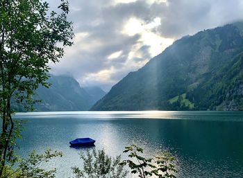 Scenic view of lake and mountains against sky