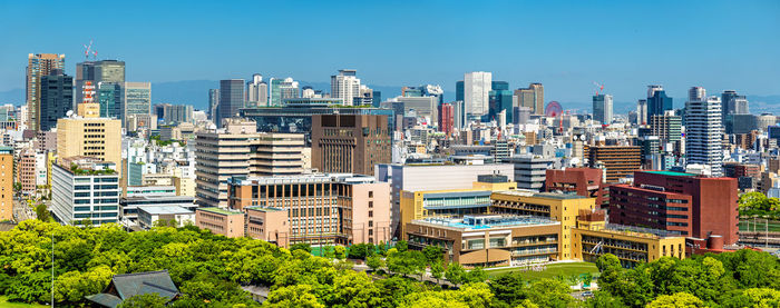 Modern buildings in city against clear sky