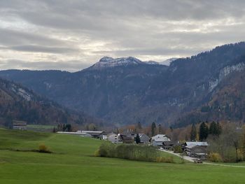 Scenic view of field and mountains against sky