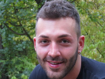 Close-up portrait of smiling man against plants