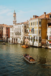 High angle view of boats on canal by buildings in city