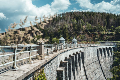 Arch bridge against cloudy sky