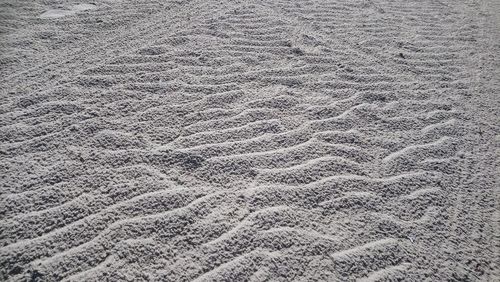 High angle view of tire tracks on sand