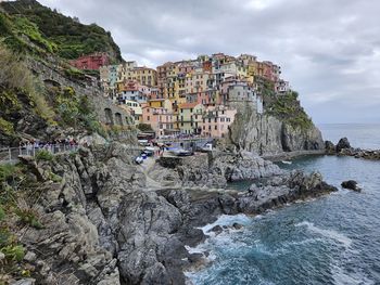 High angle view of townscape by sea against sky