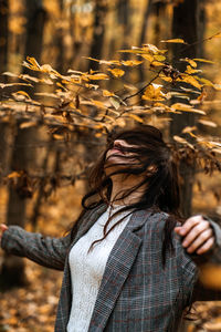 Autumn anxiety, mental health. happy brunette woman enjoy life in autumn forest
