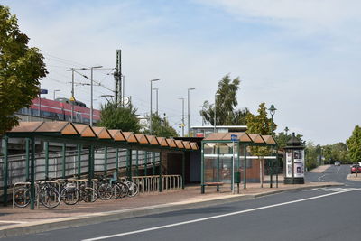 Road by building against sky